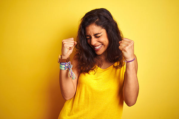 A happy woman wearing yellow smiling