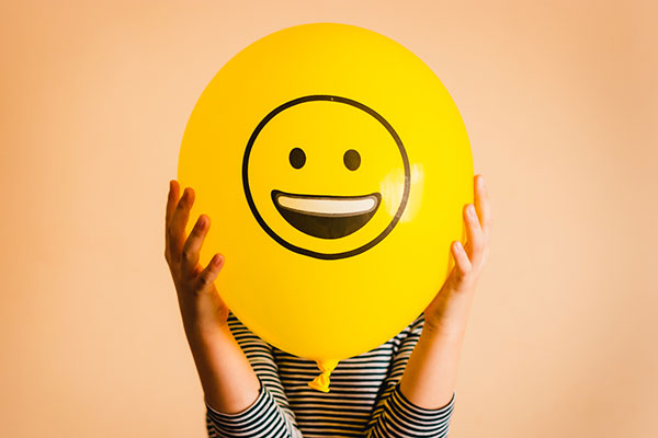 A yellow balloon with a smiley face