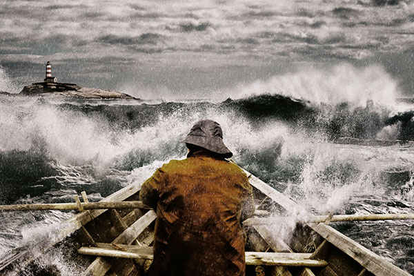A man rowing into stormy waters