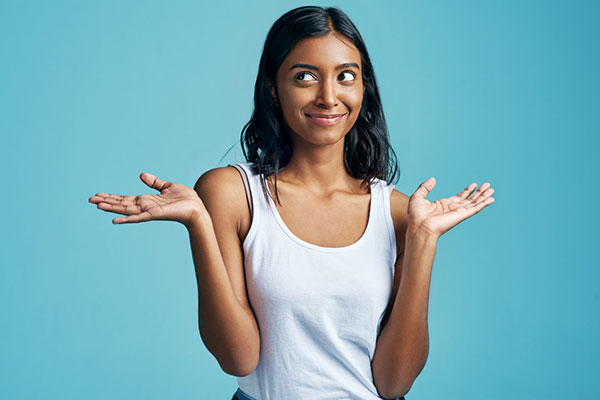 A young woman shrugging her shoulders