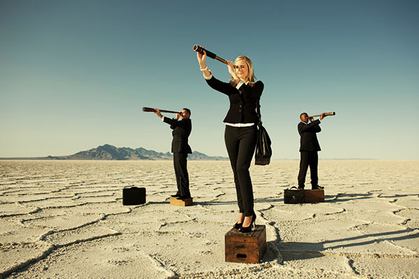 A group of people looking through a telescope in the desert