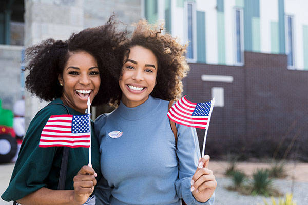 Two Americans waving flags