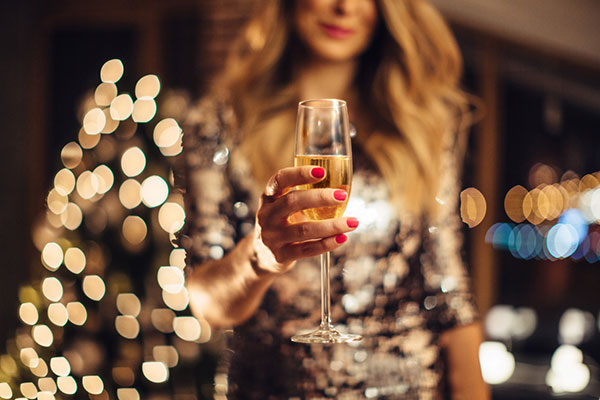 A woman holding a glass of champagne