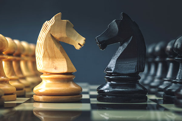 Two knight chess pieces: a clash of the titans