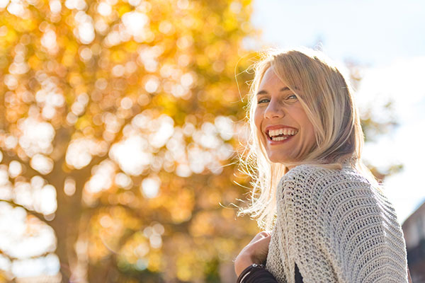 A woman smiling in winter sunshine