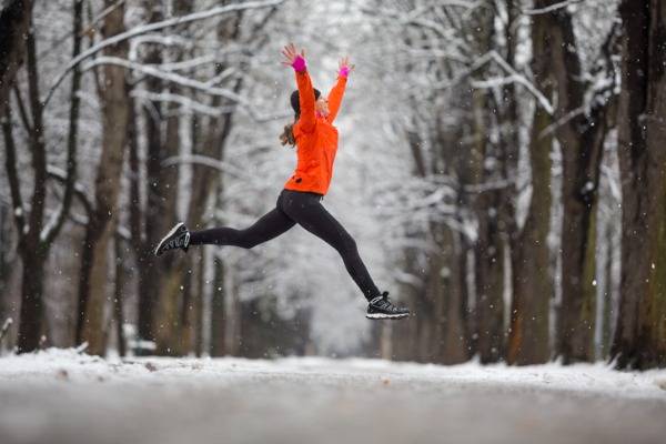 jump-side-view-woman-jumping-for-joy-in-winter-picture