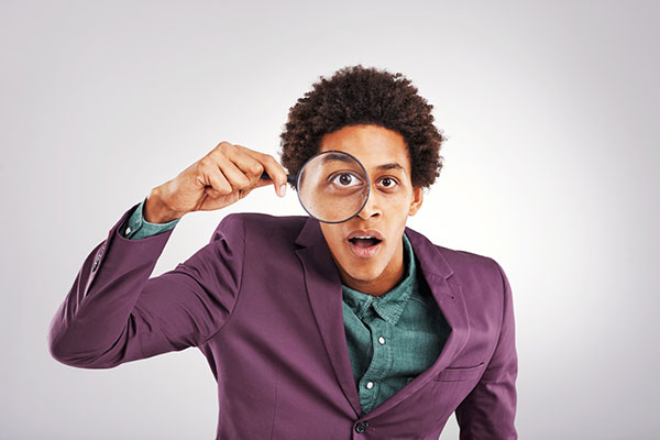 An investor using a magnifying glass