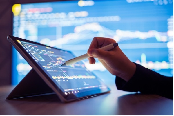   Woman looking at stock market data on smartphone picture.