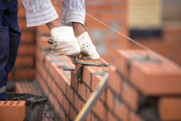house-home-builder-lays-bricks-wall-on-a-rope-with-trowel-picture