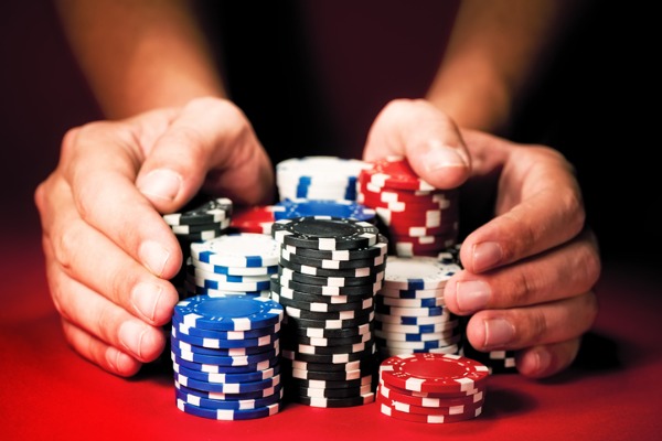 mans-hands-move-the-winnings-casino-chips-bet-gamble-poker-600