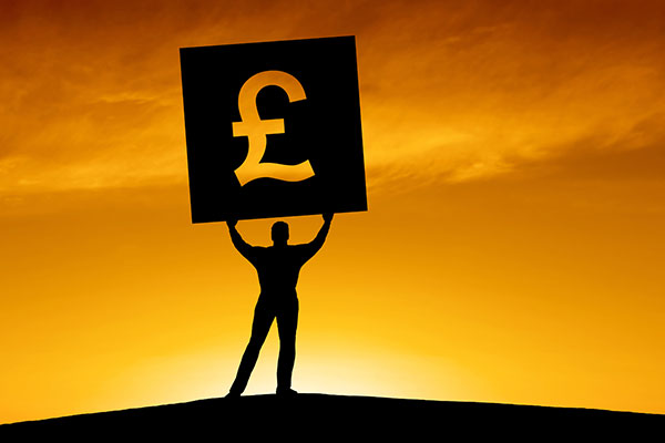 Investor holding up pound symbol 600