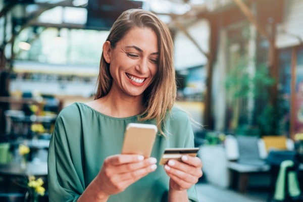 girl-holding-credit-card-and-texting