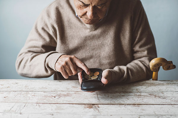 A pensioner counting coins 600