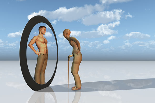 Longevity: an older man sees a youthful body in a mirror 600