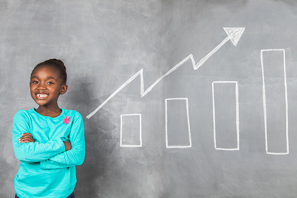 Young child smiling beside a chart showing savings growth 600