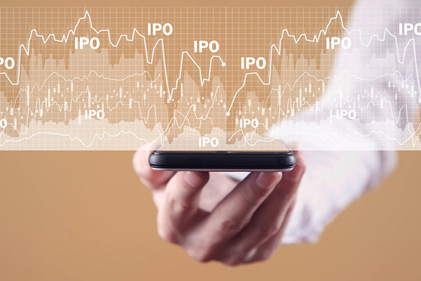 A mobile phone representing trading under a graph labelled with IPOs 600