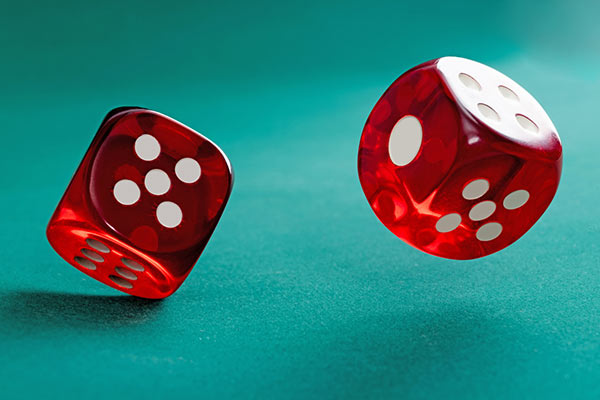  Two red dice against a green background