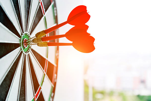 A dartboard with three arrows in it 600