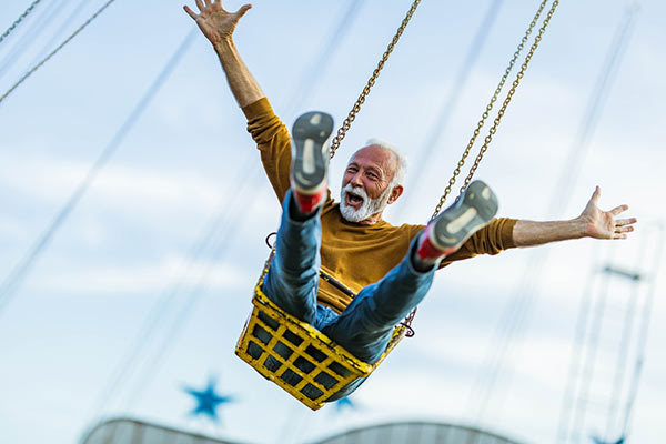 A retired man happy at the fairground