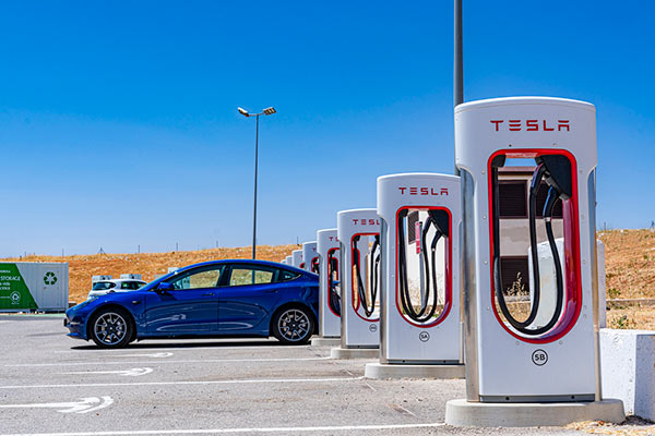 Tesla charging at vehicle charger station
