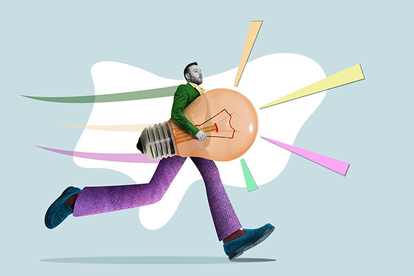 A man running with a lightbulb representing a new creative idea 600