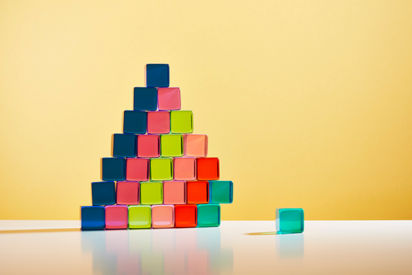 A pyramid of transparent cubes with one that would balance the pile Getty
