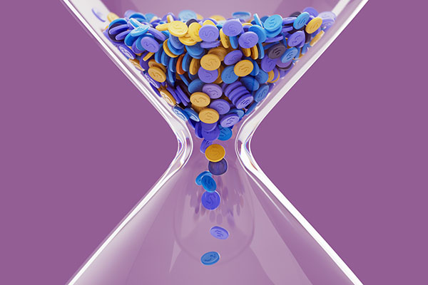 An hourglass with chips falling through Getty