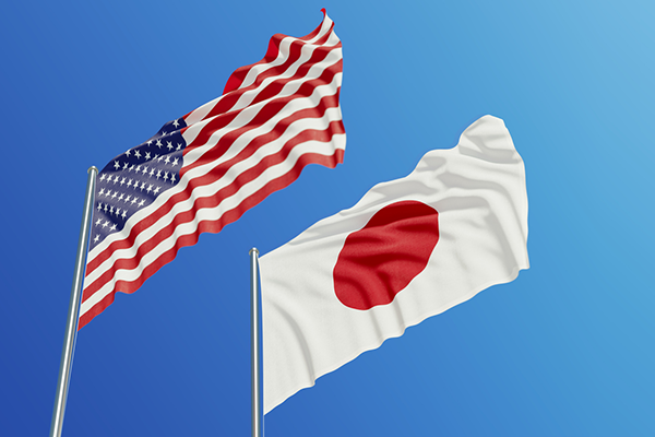 US and Japan flags waving in the breeze 600
