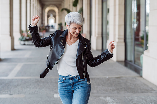 Dancing woman who is happy about making the most of tax breaks Getty