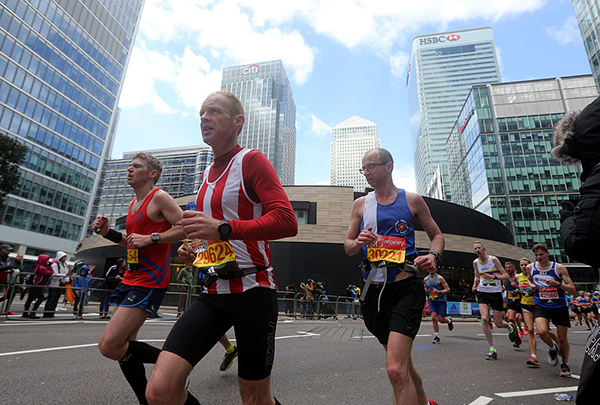 London marathon runners pass Canary Wharf Getty