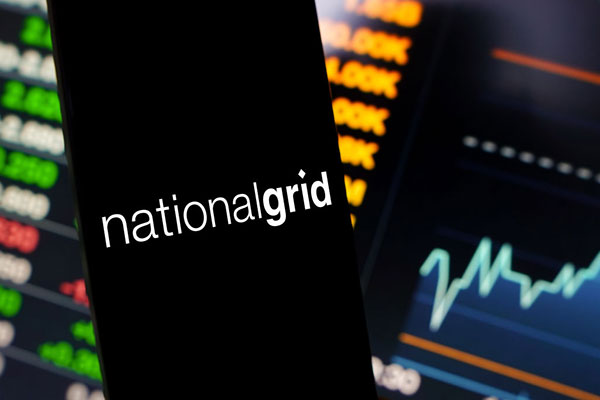 National Grid logo on a smartphone against a trading screen Getty