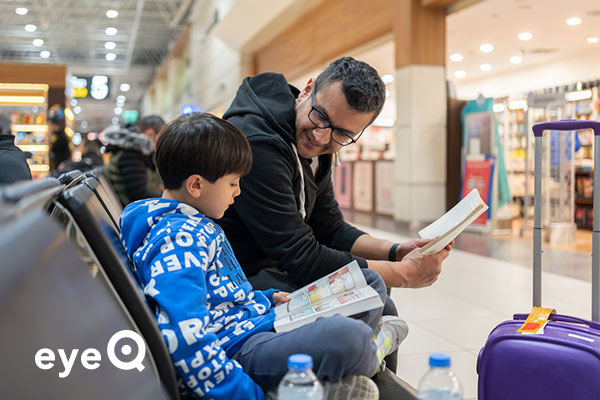 eyeQ father and son reading at the airport