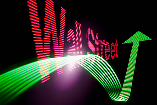 Wall Street sign with a green up arrow 