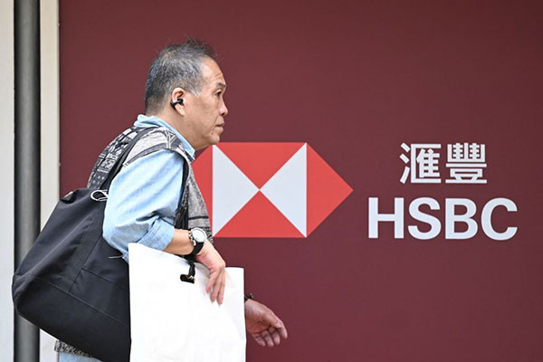 Man walking past HSBC branch in Hong Kong Getty