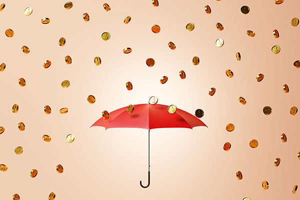 Coins raining down on an umbrella Getty