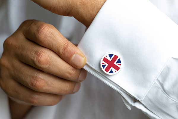 Investor with Union flag cufflinks on his shirt