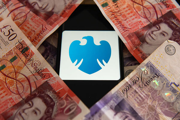 Barclays bank logo amid British banknotes Getty