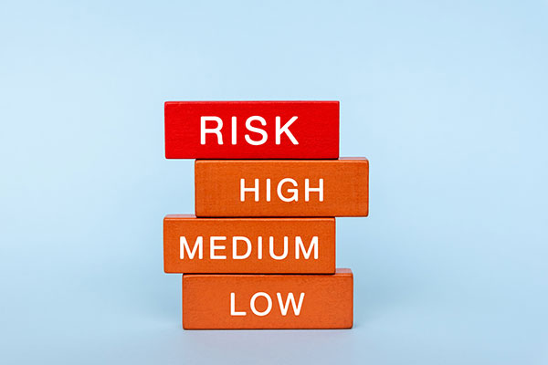 Wooden blocks with the words 'risk' 'high' 'medium' and 'low' written on them Getty