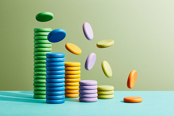  Stacks of coloured coins with coins falling off the piles Getty