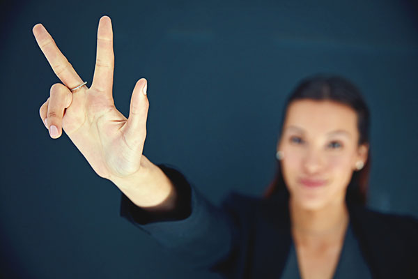 Third time lucky concept with woman holding up three fingers