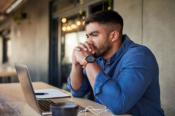 Self-employed working sitting in front of laptop