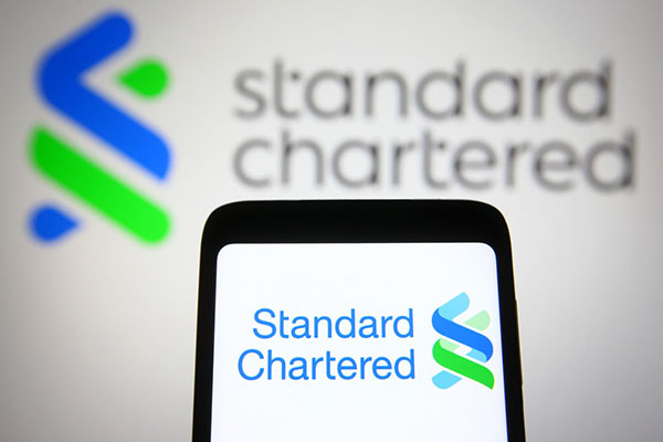 Standard Chartered logo on smartphone