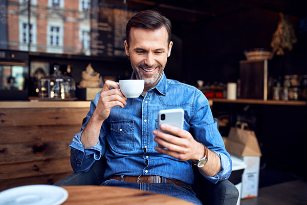 Investor drinking coffee and looking at stocks