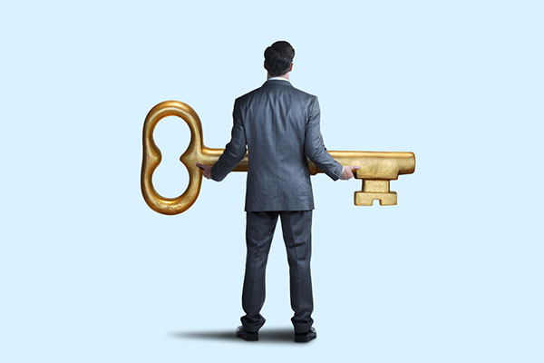 A man holding a giant key