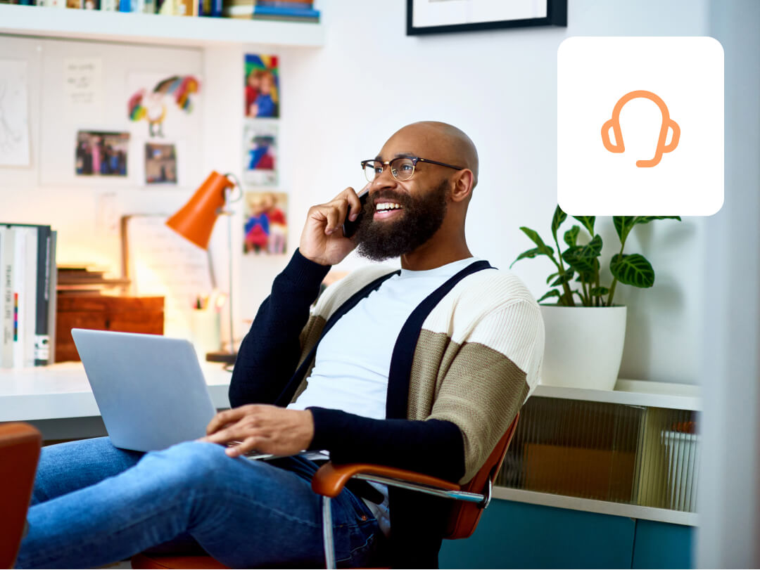 man sat at desk on phone to support