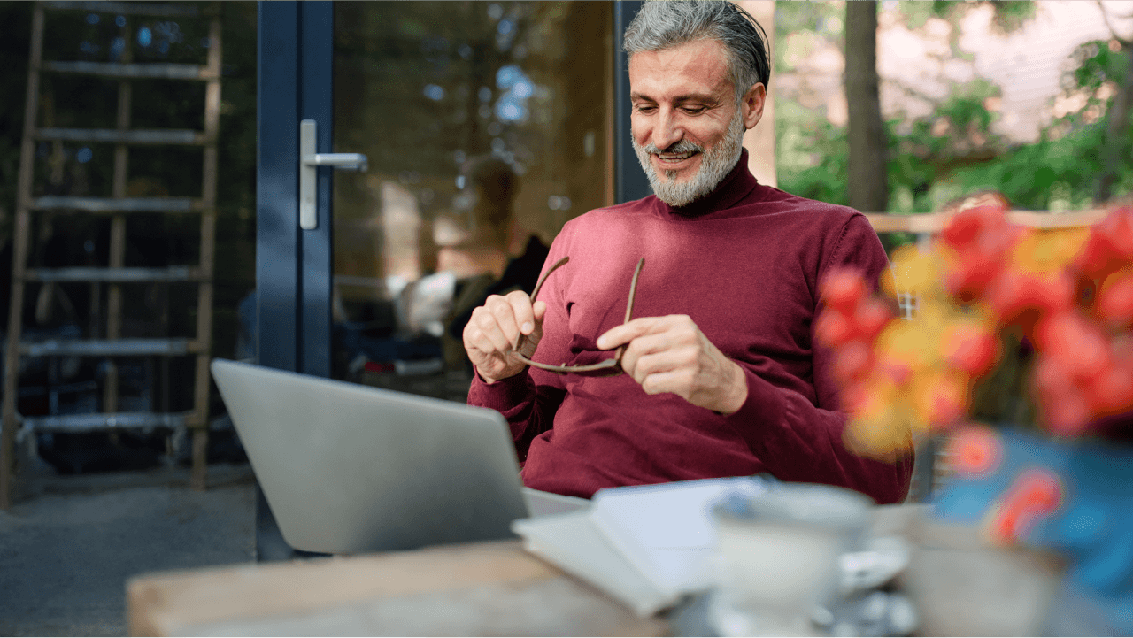 Man with glasses on laptop