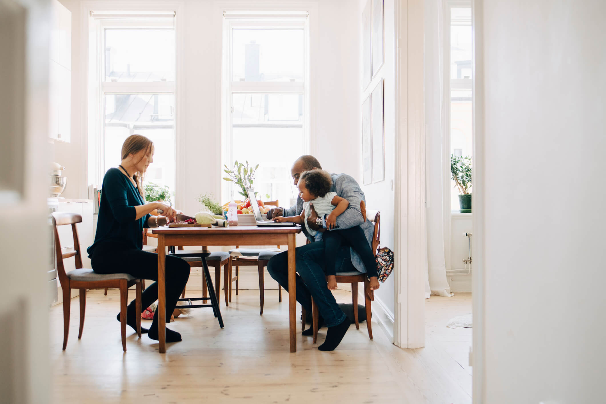 parents and child at kitchen table