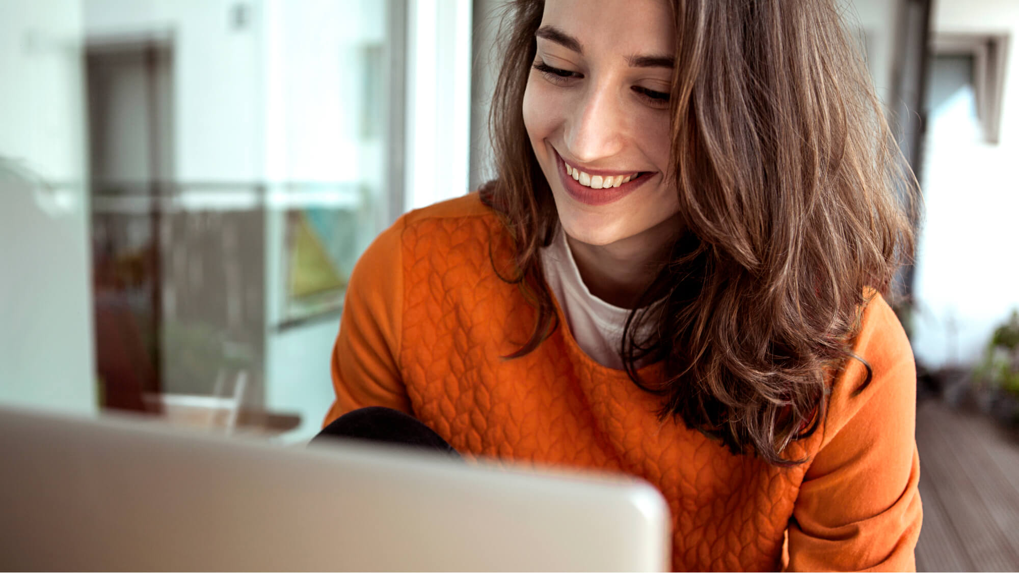 Woman looking at self managed ISA on laptop