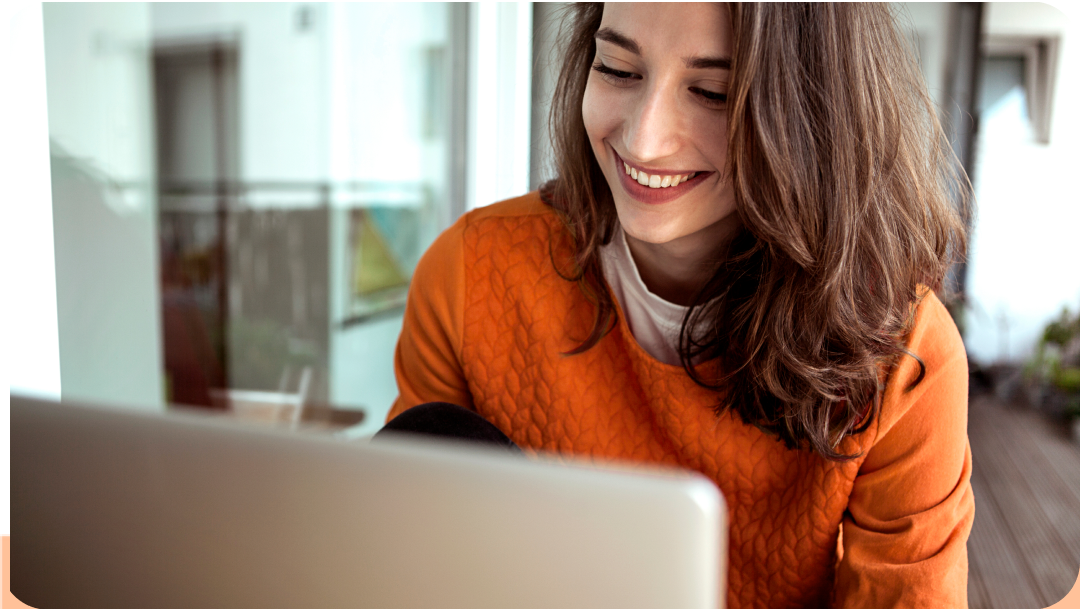 young woman smiling using laptop