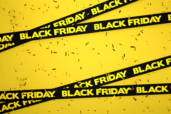 Black Friday written on black ribbons on a yellow background